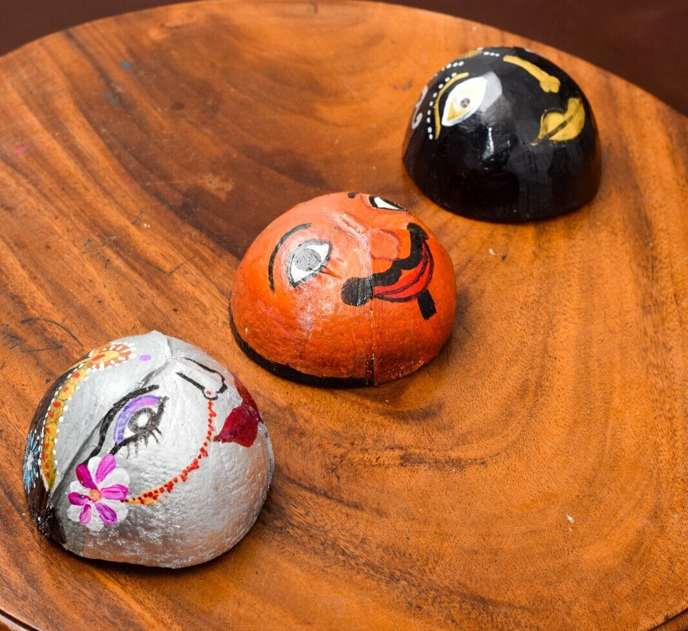 Coconut shells hand painted with different faces specified for hotel decorations