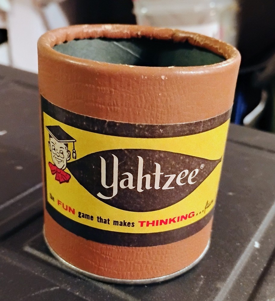 vintage yatzee cup and 5 red bakelite dice