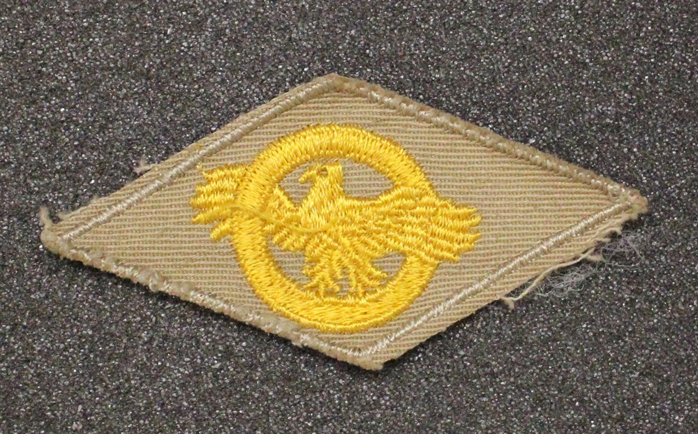 Cloth Military Badge: WWII Discharge Diamond, Ruptured Duck - on khaki