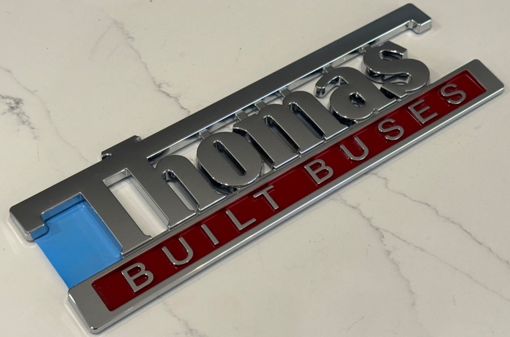 9" THOMAS BUILT BUSES EMBLEM WITH ADHESIVE BACK-OEM NOS NEW