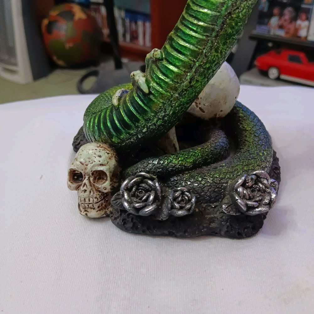 Green Cobra Snake On Skulls And Skeleton Statue