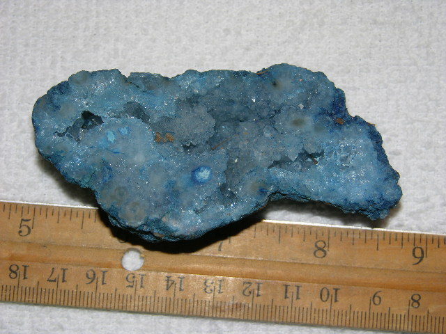 Geode cut & polished half with colored crystal center 4 inch E22
