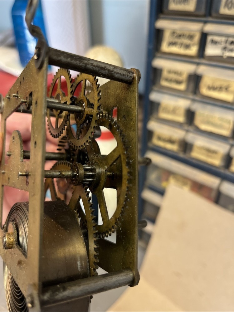 ANTIQUE E INGRAHAM CO CLOCK MOVEMENT AND PENDULUM BOB