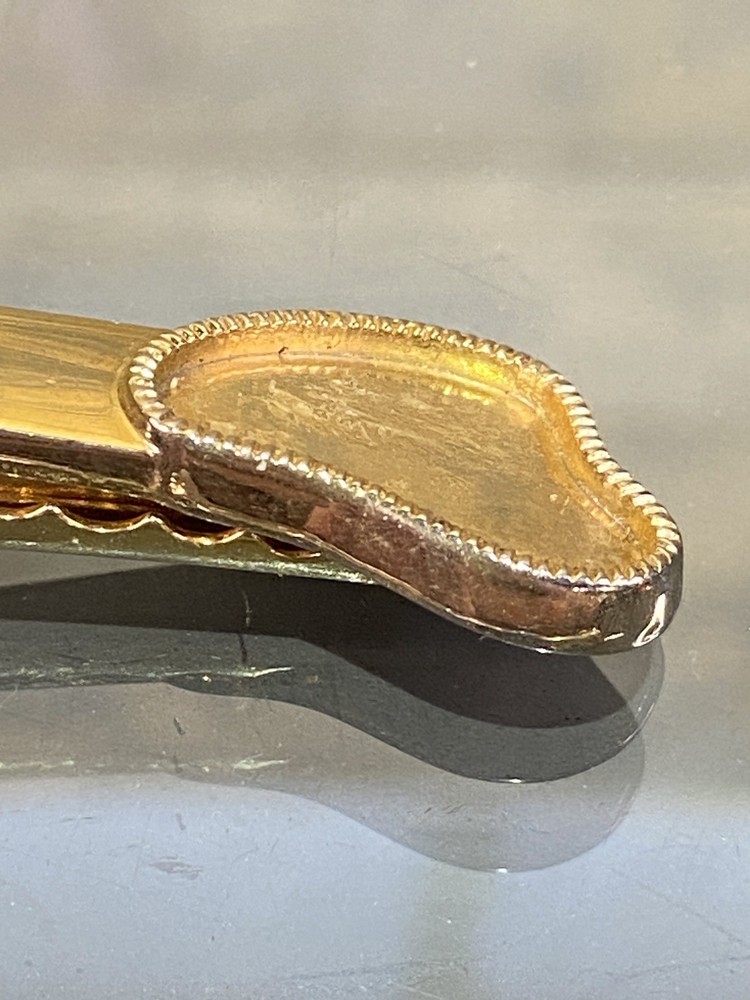 Two Tie Clips, One Marked Anson