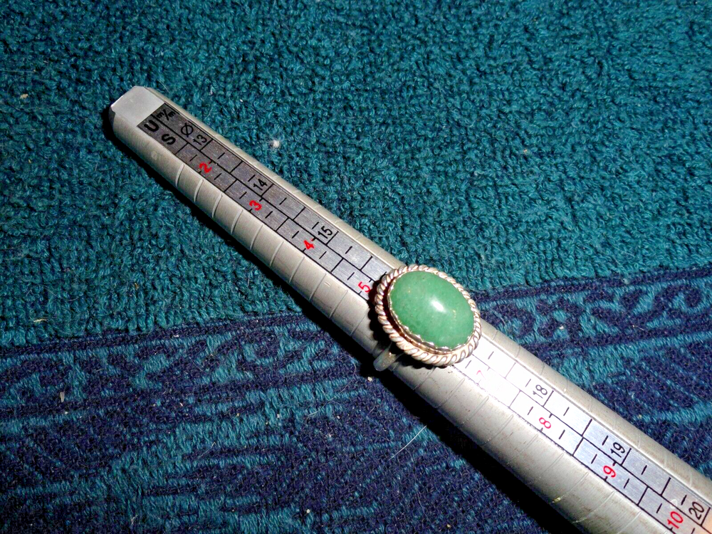 Sterling silver ring size 6 with oval shaped dark green turquoise. Signed RRT
