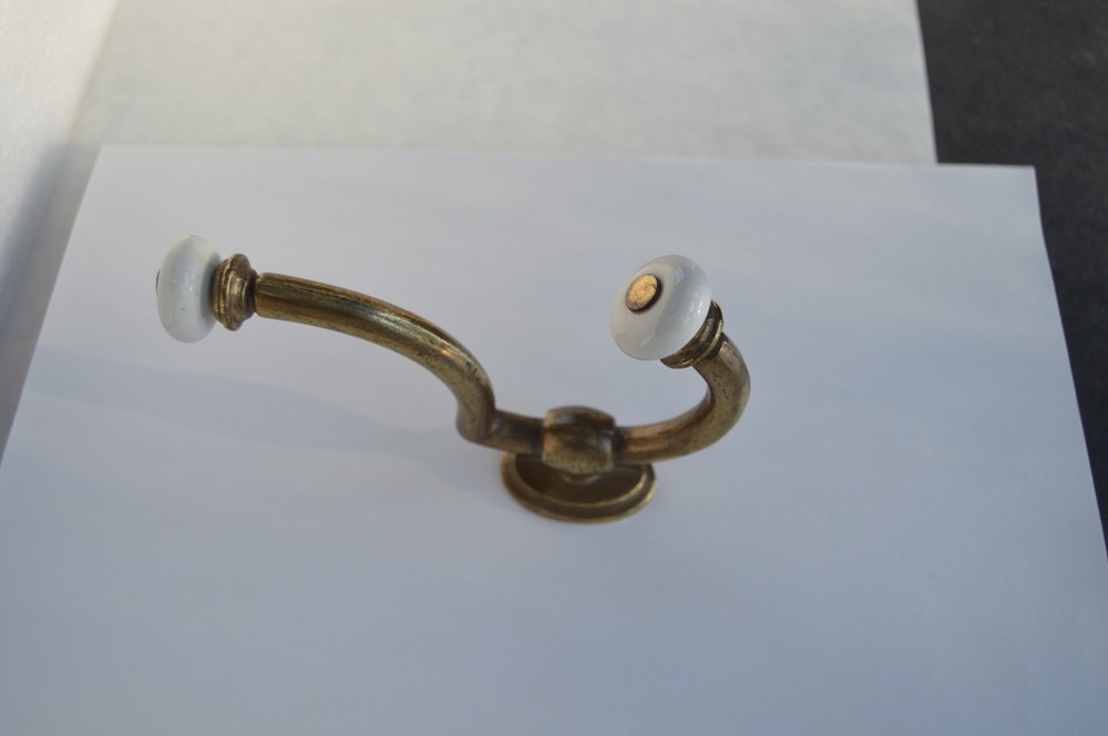 Solid brass with procelain hook that will hold securely is easy to mount .