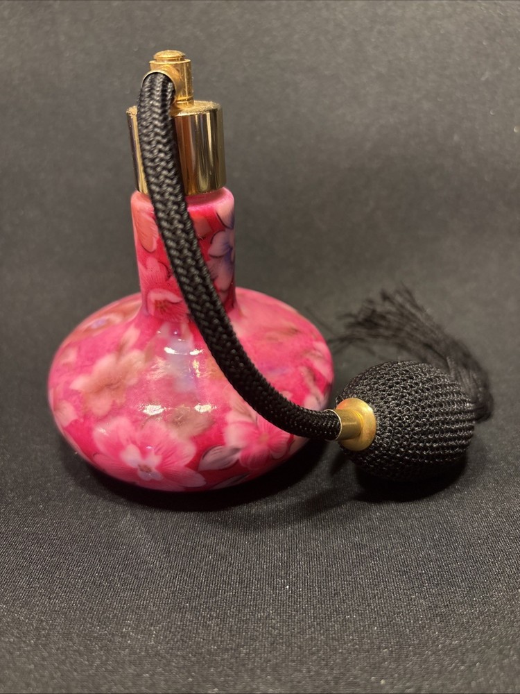 Iridescent atomizer pink perfume bottle.