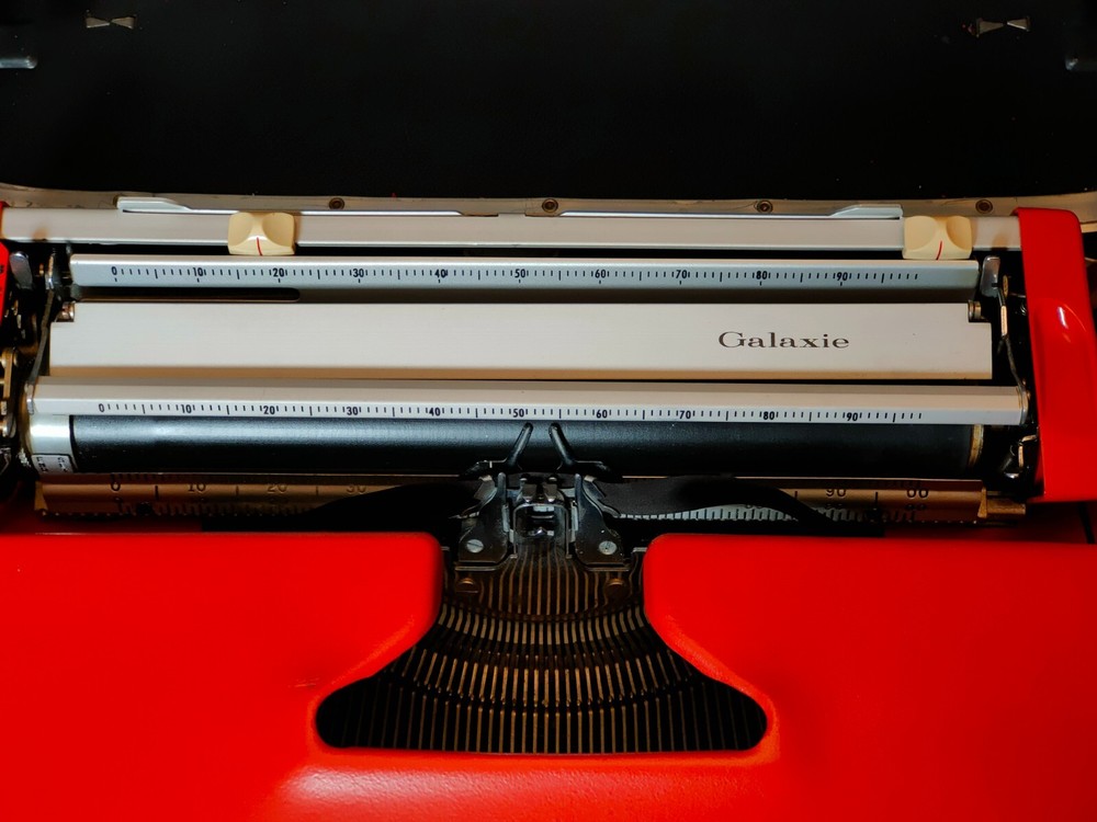 red, portable Smith Corona Galaxie typewriter with Cursive / Handwritten Script