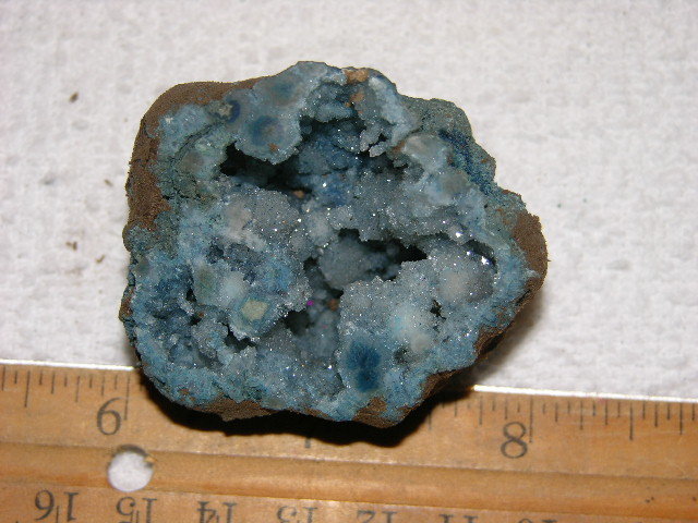 Geode cut & polished half with colored crystal center 2 inch E24