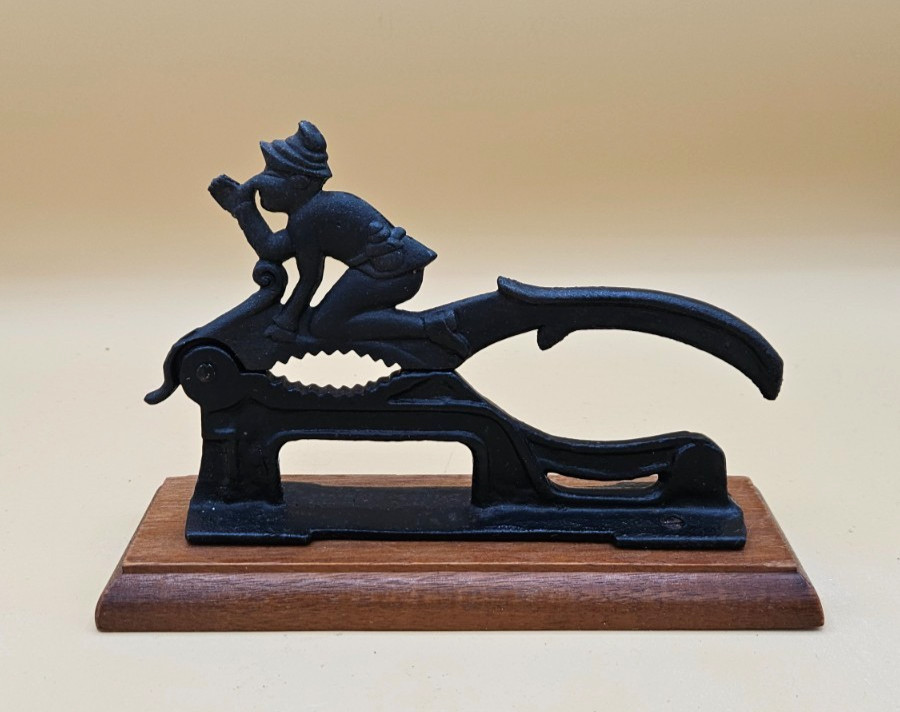 Cast Iron Nutcracker Elf Thumbing Nose Riding Bird Wood Base