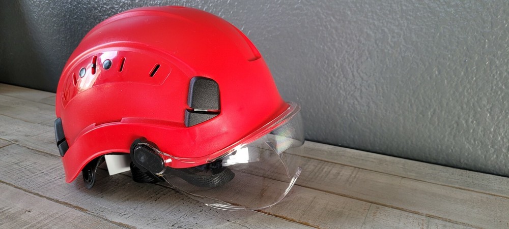 Arborist climber helmet with eye protection visor.