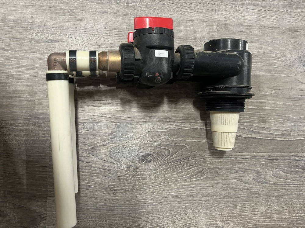 In and out valve head and bypass for a carbon tank/water filter rack