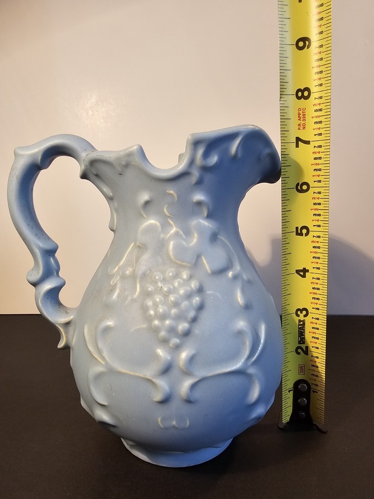 Blue Pitcher With Grapes And Leaves On The Side