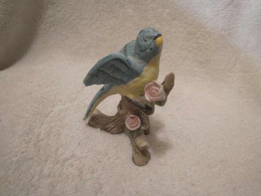 Blue ceramic parrot on tree branch 4 1/2 inches tall