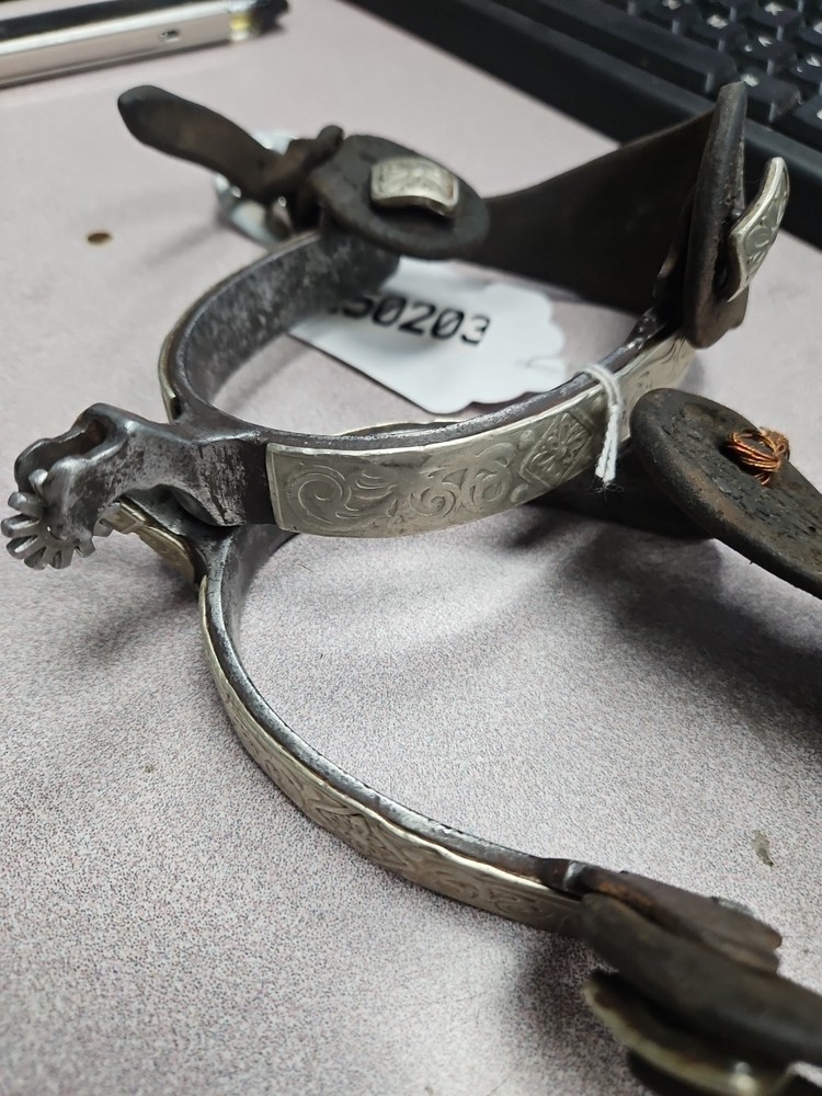 hand-forged spurs feature engraved silver inlay