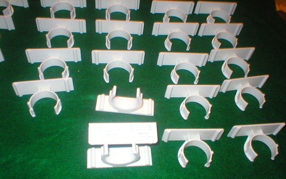 25 WHITE PLASTIC HOLDERS WITH ADHESIVE STRIPS LOT SOLD AS IS