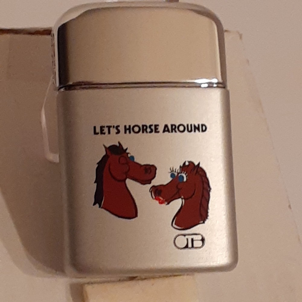 Ronson typhoon lighter. OTB horses. New in the box.