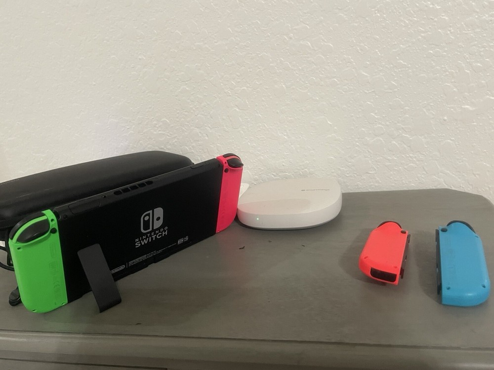 Nintendo Switch Including The Case, And Four Joy controllers.