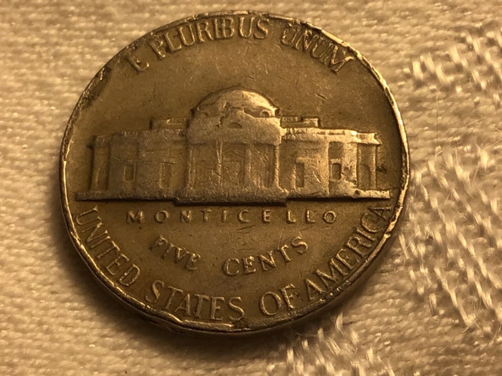 1964 jefferson nickle error on front and back edges.