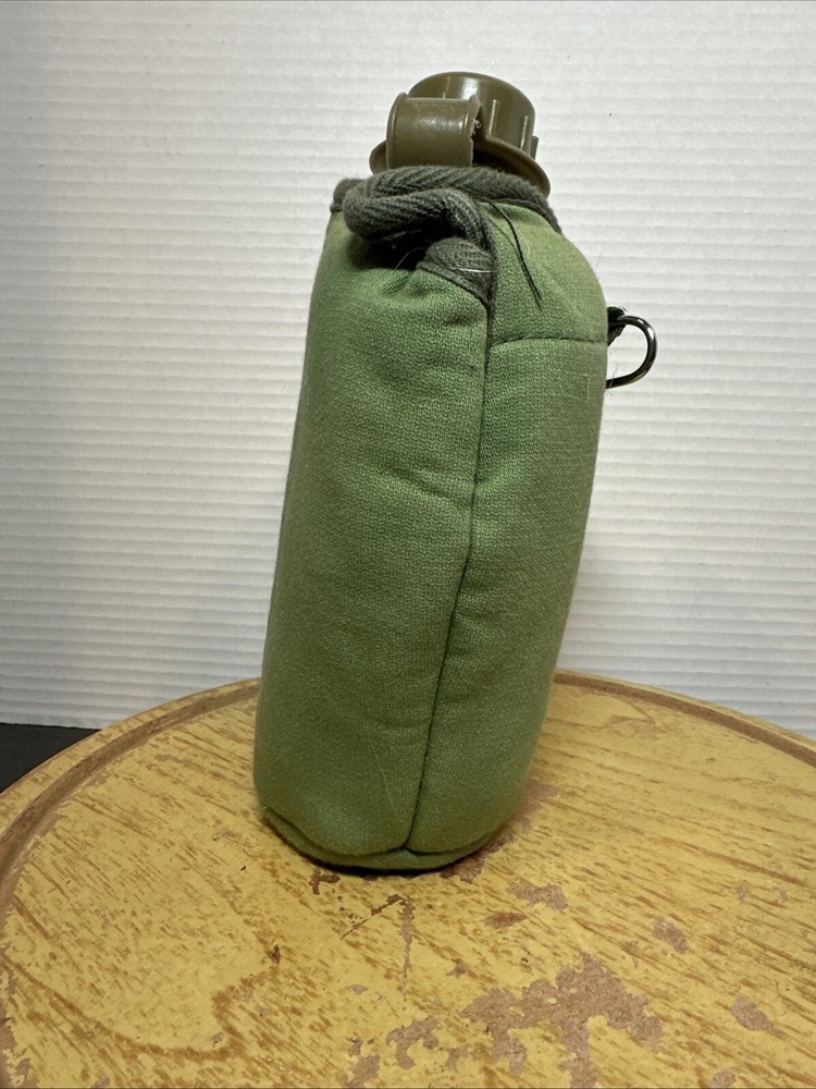 8" Green Plastic Canteen with Cloth Cover.