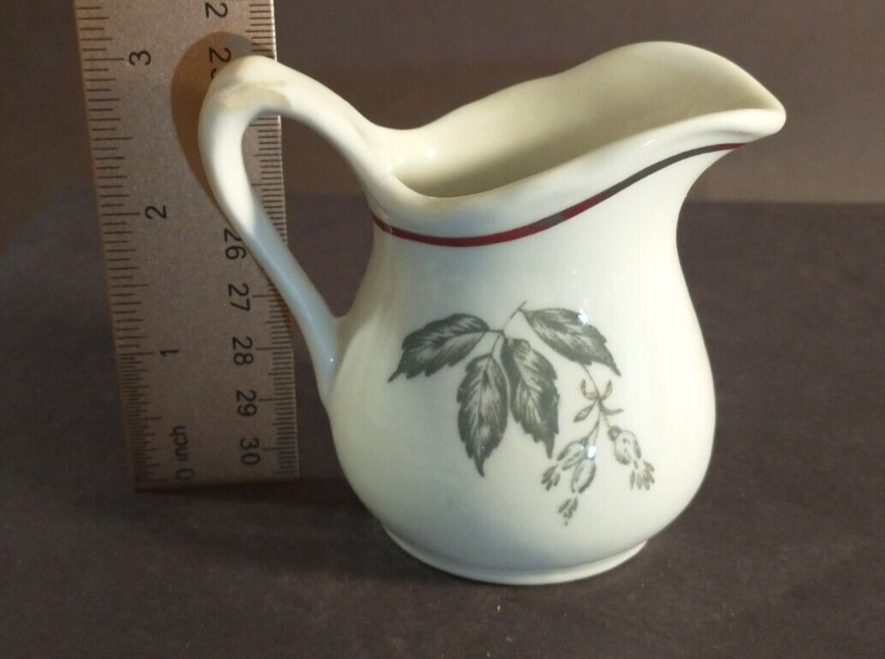 McNicol small creamer with glaze damage on handle