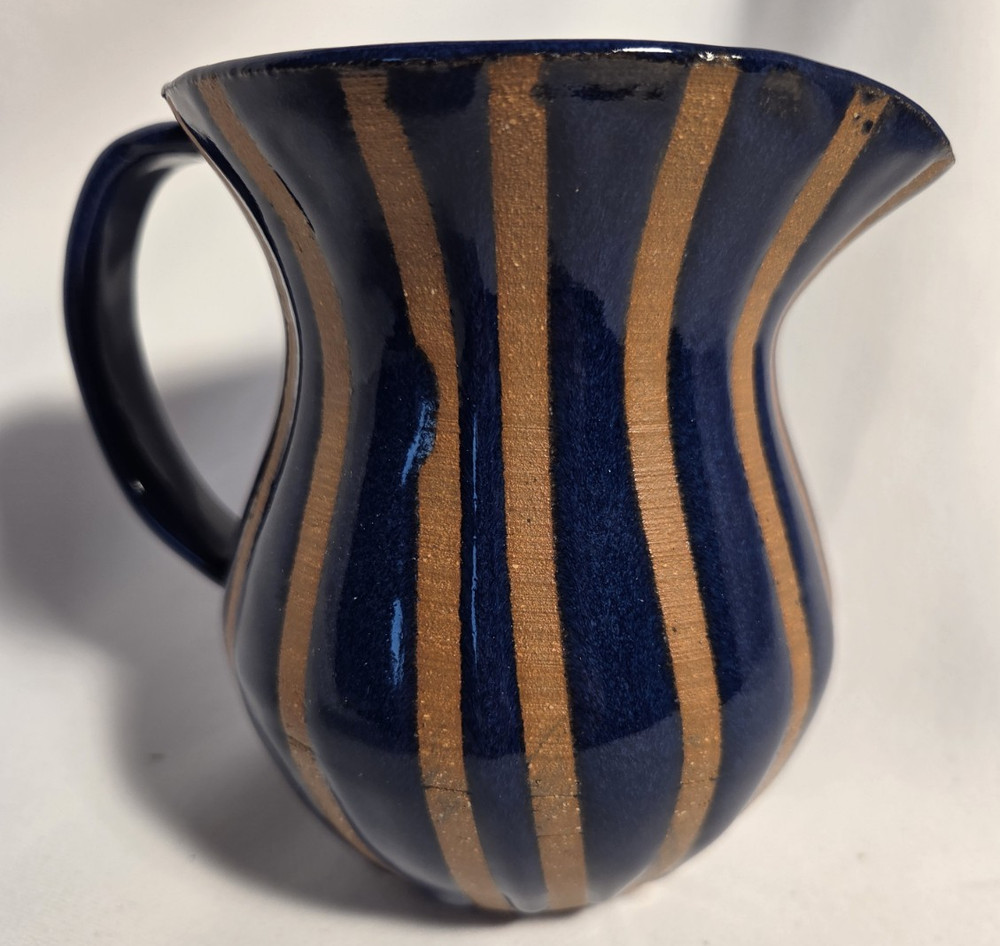 Pottery pitcher 2 toned with handle.