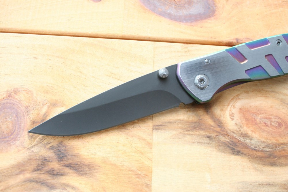 Gentleman frame lock folding knife with rainbow anodized handle. 17.6 cm overall