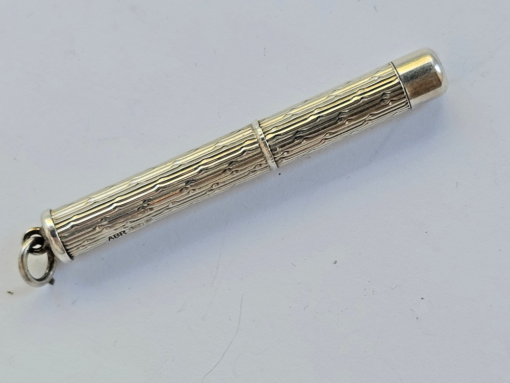Engine turned silver tooth pick with plastic tool