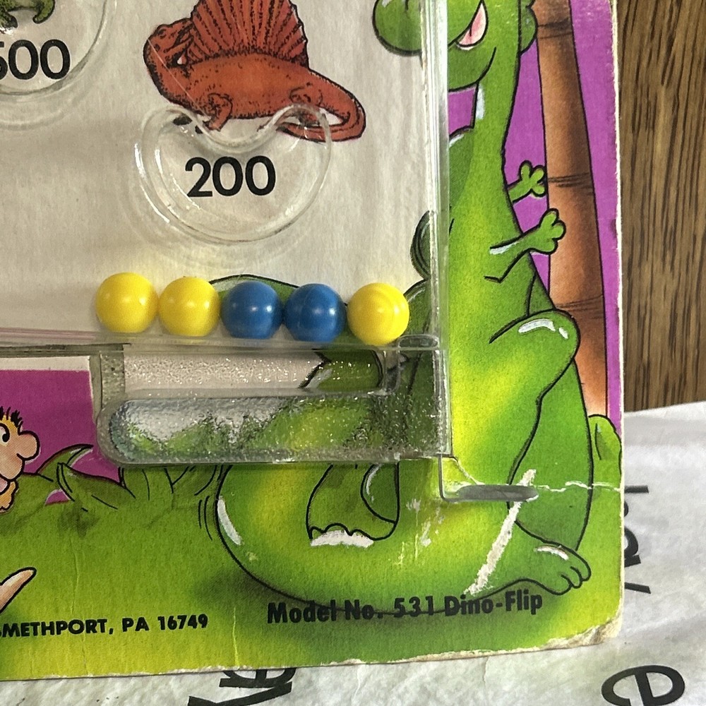 Vintage 1987 Din-o-Flip Handheld Game.
