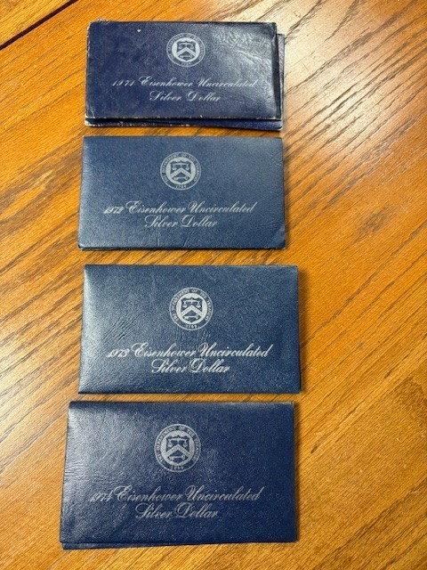 1971-1974 Eisenhower Uncirculated 40% Silver Dollars (4 Blue Envelopes w/coins)