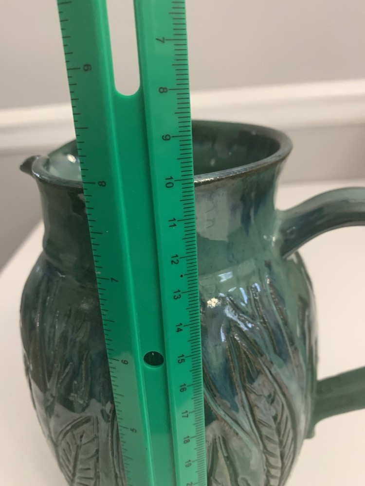 Signed Handcrafted Pottery Pitcher W/ Teal Green Glaze & Raised Leaf Pattern