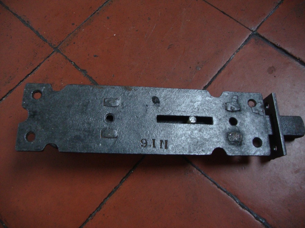 Antique very substantial antique cast iron security door bolt with inset keep