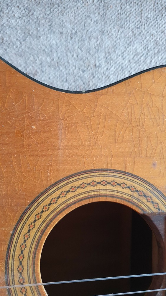 Old guitar with a nicely flamed back, needs service