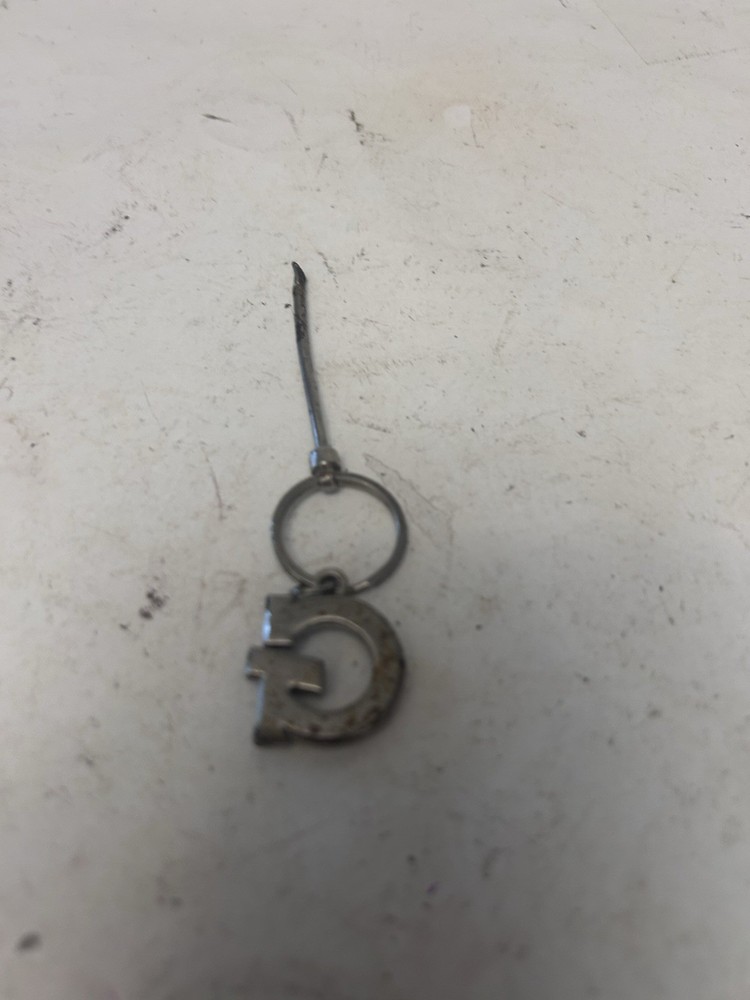 "G" keychain with small spoon scooper used