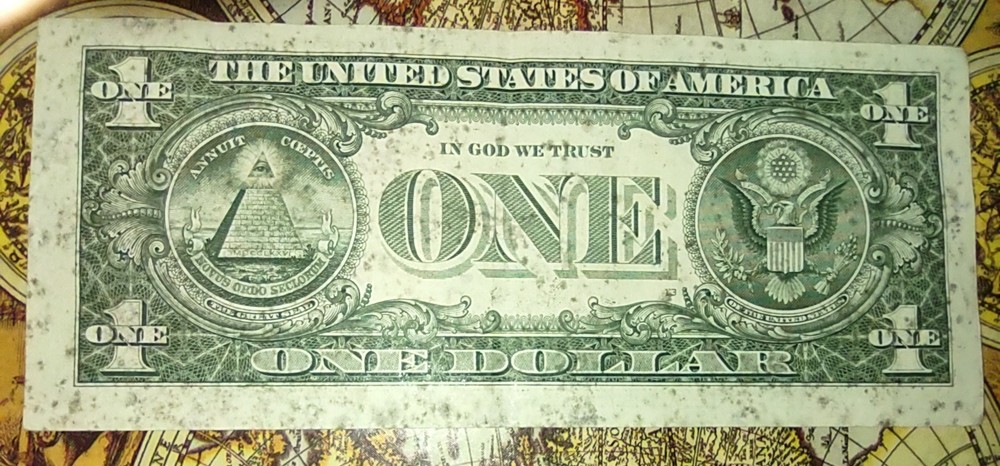 RARE ONE DOLLAR BILL WITH BLACK INK SPLASHED ALL OVER THE FRONT AND BACK.