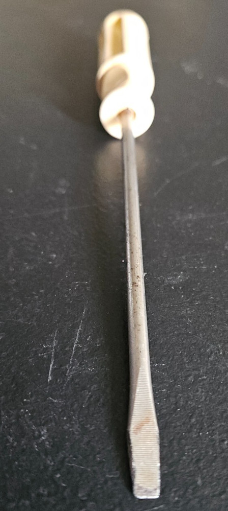 FLATHEAD SCREW DRIVER. WHITE DIMPLED PLASTIC HANDLE. UNMARKED