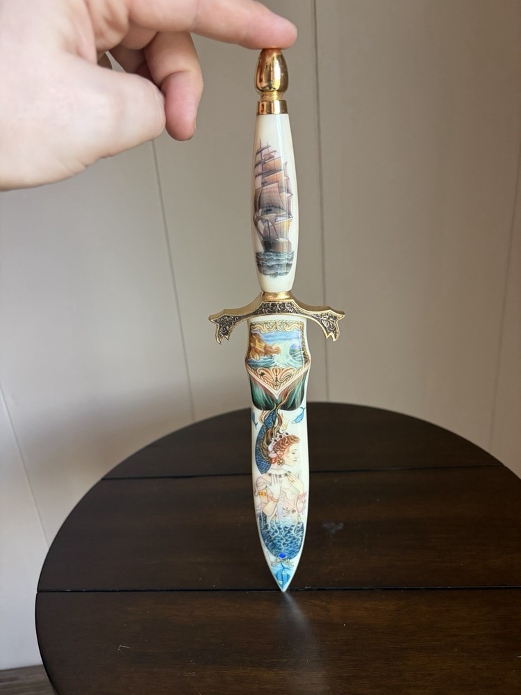 Dagger with pseudo-scrimshaw mermaids