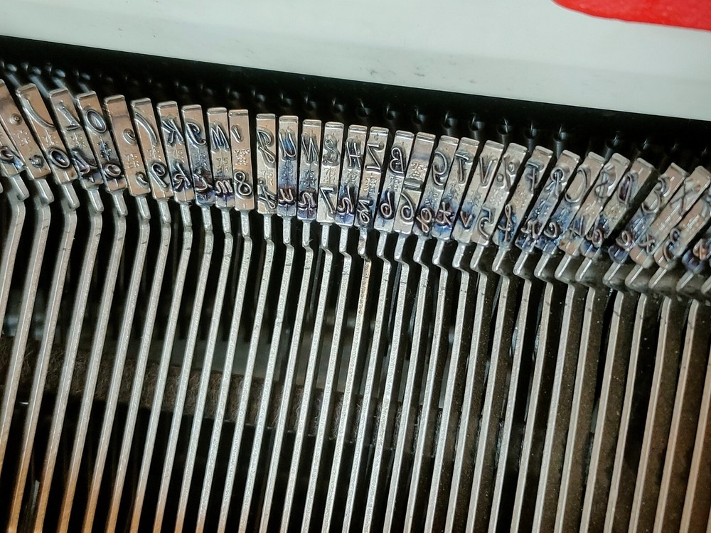 red, portable Smith Corona Galaxie typewriter with Cursive / Handwritten Script