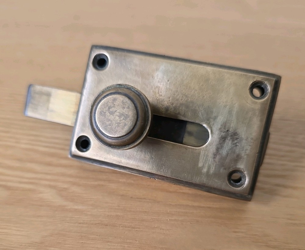 Antique brass vacant-engaged WC bathroom lock.