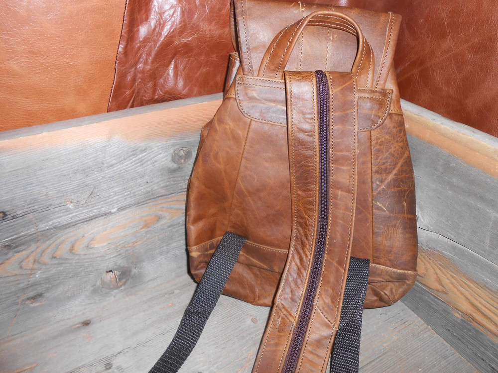Leather backpack.New small to medium sized backpack spacious with zipper pockets