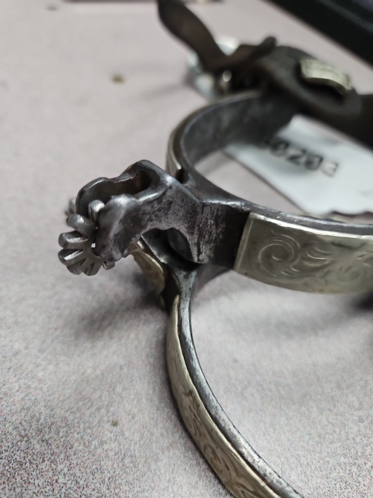 hand-forged spurs feature engraved silver inlay