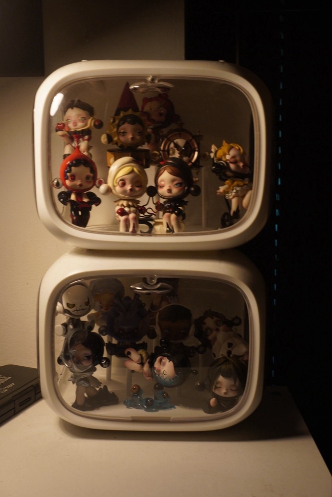 White display case with 17 Skillpanda figures. both in excellent condition