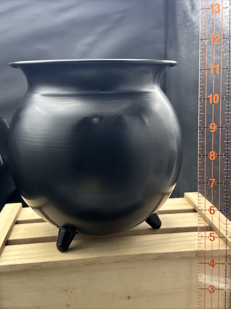 Metal Cauldron Has Bats Cut Out .
