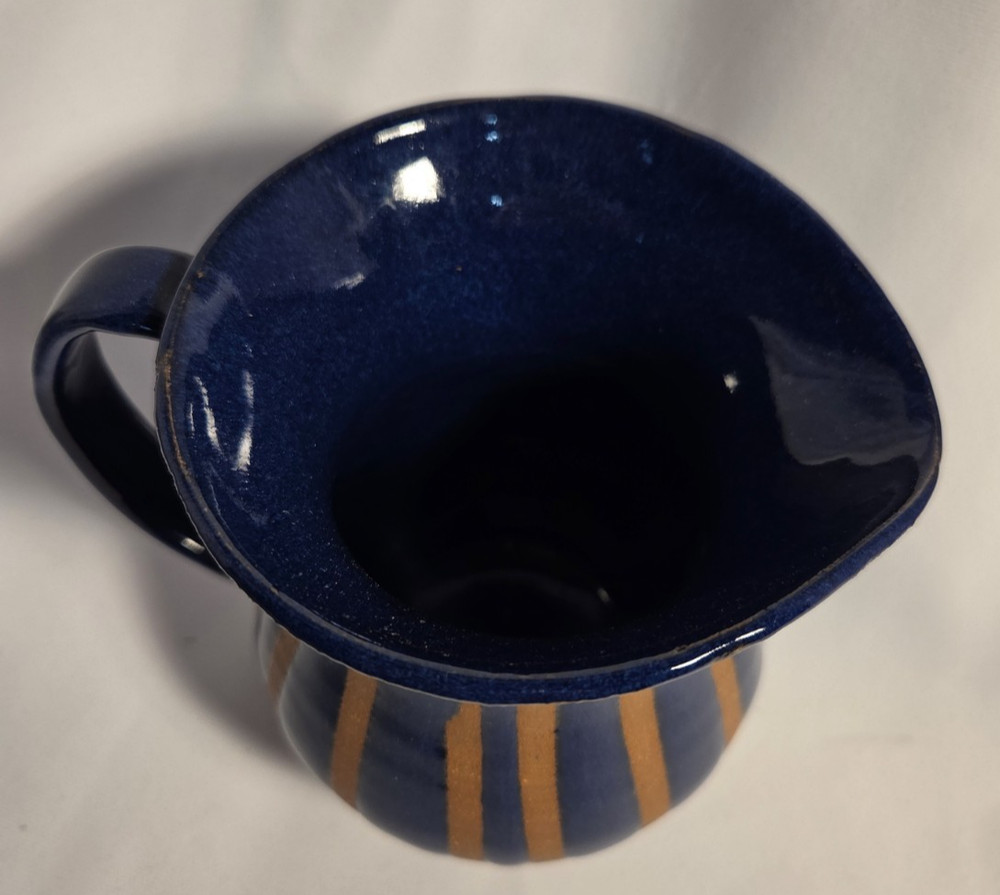 Pottery pitcher 2 toned with handle.
