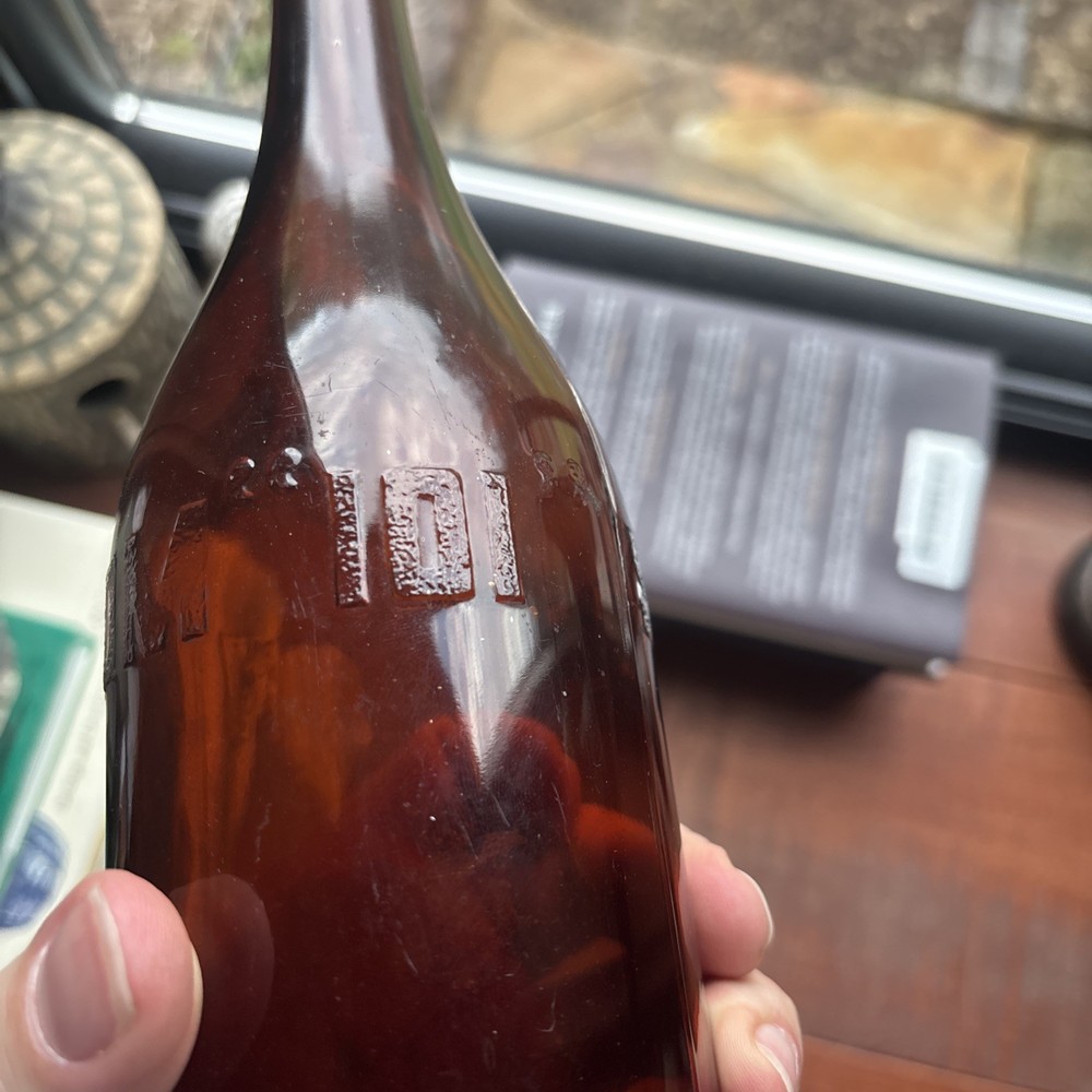 Stains Run From 101 Amber Embossed Bottle