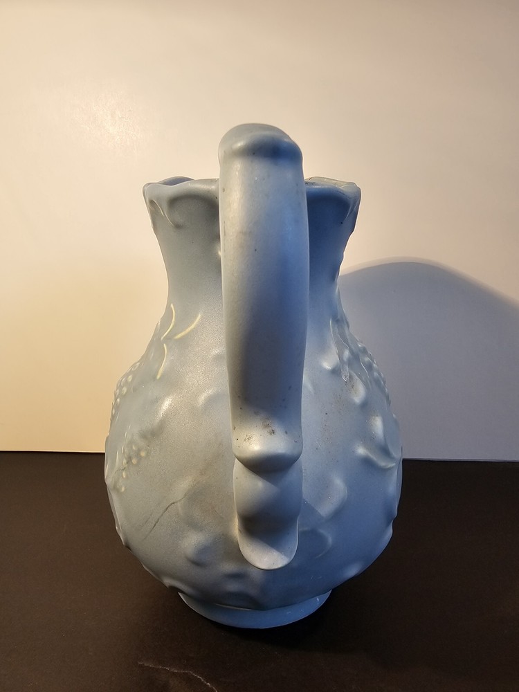 Blue Pitcher With Grapes And Leaves On The Side