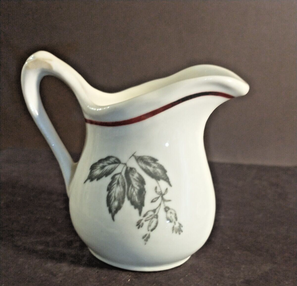 McNicol small creamer with glaze damage on handle