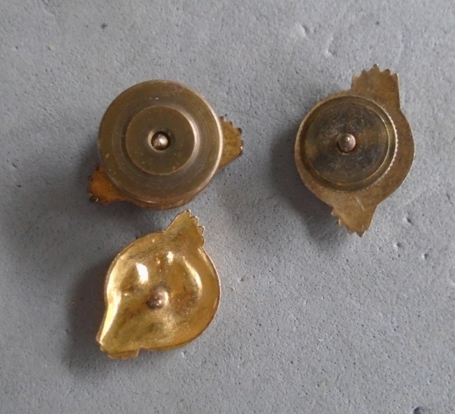 WWII screwback ruptured duck pins, one missing screw