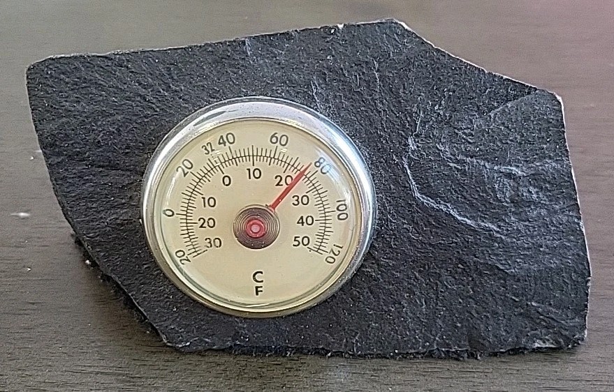 Vintage Desktop Thermometer on Jagged Stone.