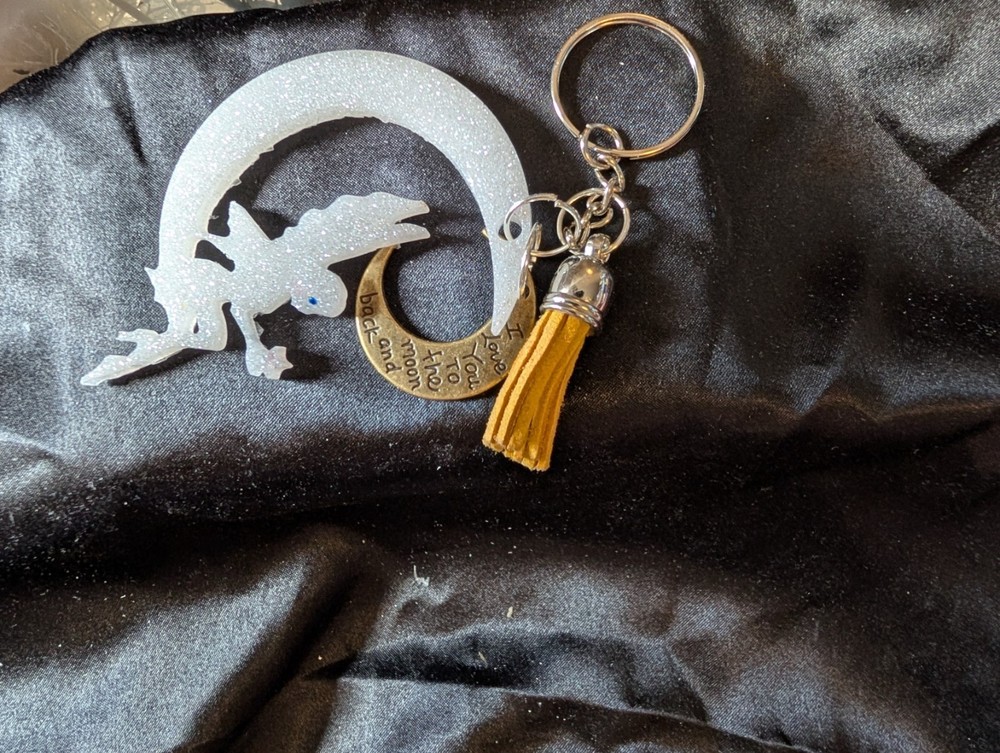 Fairy sitting on moon with good message.  Keychain or purse pull.